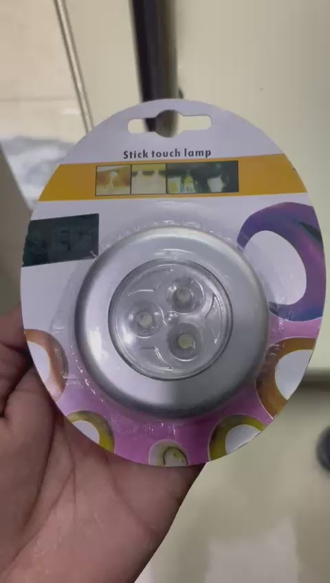 LED sticky tap light close-up showing adhesive backing