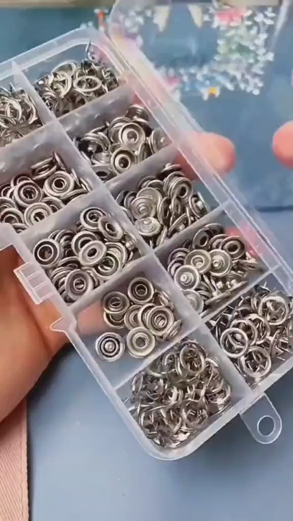 Metal snap button tool kit with included buttons on white background